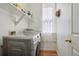 Bright laundry room featuring a modern washer and dryer and ample shelving space at 19157 E Progress Ave, Centennial, CO 80015