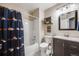 Bright bathroom with a shower-tub combo and Broncos-themed shower curtain at 9377 Weeping Willow Ct, Highlands Ranch, CO 80130