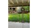 Relaxing covered patio with string lights and hanging plants overlooks the lush, green backyard at 9377 Weeping Willow Ct, Highlands Ranch, CO 80130