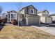 Charming two-story home features a well-maintained lawn, complemented by an attached two-car garage at 9377 Weeping Willow Ct, Highlands Ranch, CO 80130