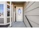 Inviting front entrance with a decorative welcome sign and a glass-paneled door at 9377 Weeping Willow Ct, Highlands Ranch, CO 80130