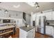 Open concept kitchen featuring an island, stainless steel appliances, and modern lighting at 9377 Weeping Willow Ct, Highlands Ranch, CO 80130