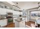 Well-lit kitchen featuring stainless steel appliances, white cabinets, and an island at 9377 Weeping Willow Ct, Highlands Ranch, CO 80130