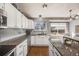 Bright kitchen area with granite counters, stainless appliances, and views to the outdoors at 9377 Weeping Willow Ct, Highlands Ranch, CO 80130