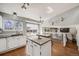 Kitchen with island, stainless steel appliances, adjacent dining room and living room views at 9377 Weeping Willow Ct, Highlands Ranch, CO 80130