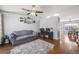 Comfortable living room featuring a ceiling fan, hardwood floors, and adjacent office area at 9377 Weeping Willow Ct, Highlands Ranch, CO 80130