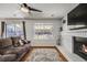 This living room is a comfortable space, highlighted by a gray sofa and a fireplace at 9377 Weeping Willow Ct, Highlands Ranch, CO 80130