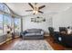 Inviting living room with lots of natural light, hardwood floors, and a comfortable gray sofa at 9377 Weeping Willow Ct, Highlands Ranch, CO 80130