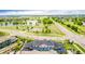 Aerial view of the community showcasing lush greenery, lake, and residential buildings at 619 Brennan Cir, Erie, CO 80516