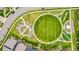 Aerial view of a green neighborhood park featuring gardens, shuffleboard, and bocce ball courts, perfect for community enjoyment at 619 Brennan Cir, Erie, CO 80516