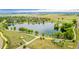 Beautiful aerial view of the community lake with surrounding walking paths and green spaces at 619 Brennan Cir, Erie, CO 80516