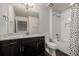 Modern bathroom featuring dark wood vanity, white countertop, and combined shower and tub at 619 Brennan Cir, Erie, CO 80516