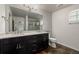 Modern bathroom featuring double sink vanity with quartz countertop and tiled floors at 619 Brennan Cir, Erie, CO 80516