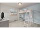 Unique bedroom with loft bed and desk area features great light from the large window at 619 Brennan Cir, Erie, CO 80516