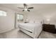 Bright bedroom with neutral tones, large window and a comfortable king-size bed with white bedding at 619 Brennan Cir, Erie, CO 80516