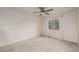 Empty carpeted bedroom with a ceiling fan and natural light entering through the window at 619 Brennan Cir, Erie, CO 80516