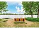 Community bench offering serene lake views in a tranquil setting on a sunny day at 619 Brennan Cir, Erie, CO 80516