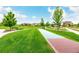 Green community space with a shuffleboard, benches, walking paths and trees at 619 Brennan Cir, Erie, CO 80516