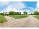 Scenic view of a community walking path leading to a gazebo with lake views on a sunny day at 619 Brennan Cir, Erie, CO 80516