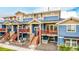 Beautiful multi-level townhome featuring blue siding, a stone base, and a red door at 619 Brennan Cir, Erie, CO 80516