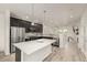 Bright modern kitchen featuring stainless steel appliances, a center island, and hardwood floors at 619 Brennan Cir, Erie, CO 80516