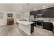 Modern kitchen features a large island, stainless steel appliances, and dark wood cabinets at 619 Brennan Cir, Erie, CO 80516