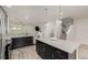 Modern kitchen with an island and stainless steel appliances and an open floorplan at 619 Brennan Cir, Erie, CO 80516