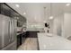 Modern kitchen with stainless steel appliances, an island, and hardwood floors at 619 Brennan Cir, Erie, CO 80516