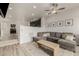 Cozy living room with gray sofa, a decorative rug, and open access to the kitchen at 619 Brennan Cir, Erie, CO 80516