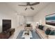 Bright living room featuring neutral tones, a ceiling fan, and comfortable seating arrangement at 619 Brennan Cir, Erie, CO 80516