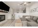 Open-concept living room featuring a gray sofa, fireplace, and wood-style flooring at 619 Brennan Cir, Erie, CO 80516