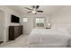 Bedroom with a large bed, dresser, TV, ceiling fan and a window providing natural light at 619 Brennan Cir, Erie, CO 80516