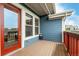Charming porch with blue siding, a red door, and views of the neighborhood at 619 Brennan Cir, Erie, CO 80516