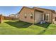 Backyard with artificial turf, wood fence, and a house with brown siding at 1820 Taos St, Brighton, CO 80603