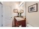 Half bathroom featuring a modern vanity with dark wood cabinets and stylish decor at 1820 Taos St, Brighton, CO 80603