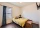 Cozy bedroom featuring wood floors, a comfortable bed, and ample natural light, creating a relaxing atmosphere at 1820 Taos St, Brighton, CO 80603