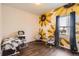 Bright bedroom with sunflower mural, dark wood floors, and Bedroom furniture at 1820 Taos St, Brighton, CO 80603