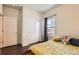 Comfortable bedroom featuring wood floors, a closet, and natural light, making it a perfect space for rest and relaxation at 1820 Taos St, Brighton, CO 80603