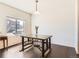 Bright dining room with dark wood floors and a modern industrial-style table at 1820 Taos St, Brighton, CO 80603