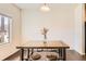 Bright dining room with dark wood floors and a modern industrial-style table at 1820 Taos St, Brighton, CO 80603