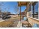 Inviting front porch with chairs and a table, great for relaxing and enjoying the neighborhood at 1820 Taos St, Brighton, CO 80603