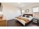 Spacious main bedroom featuring wood floors, a comfortable bed, and ample natural light from the large windows at 1820 Taos St, Brighton, CO 80603