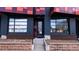 Modern exterior entrance featuring gray siding, brick accents, and large windows for ample natural light at 722 W 6Th Ave, Denver, CO 80204