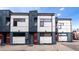 Modern townhouse with gray and white siding, featuring large windows at 722 W 6Th Ave, Denver, CO 80204