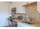 Modern kitchen features stainless steel appliances and a stylish backsplash, perfect for cooking at 722 W 6Th Ave, Denver, CO 80204