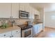 Well-appointed kitchen with stainless steel appliances, mosaic tile backsplash, and ample counter space at 722 W 6Th Ave, Denver, CO 80204