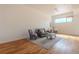 Cozy living room featuring hardwood floors, a gray sofa, stylish furniture, and natural light at 722 W 6Th Ave, Denver, CO 80204