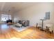 Spacious living room with hardwood floors, a large window, and contemporary furniture at 722 W 6Th Ave, Denver, CO 80204