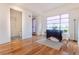 Bright living area with hardwood floors, natural light from a large window, and a cozy bathroom nearby at 722 W 6Th Ave, Denver, CO 80204