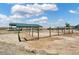 Exterior view of barn with fenced pasture area on a beautiful day with a blue sky and puffy clouds at 5537 Lake Gulch Rd, Castle Rock, CO 80104